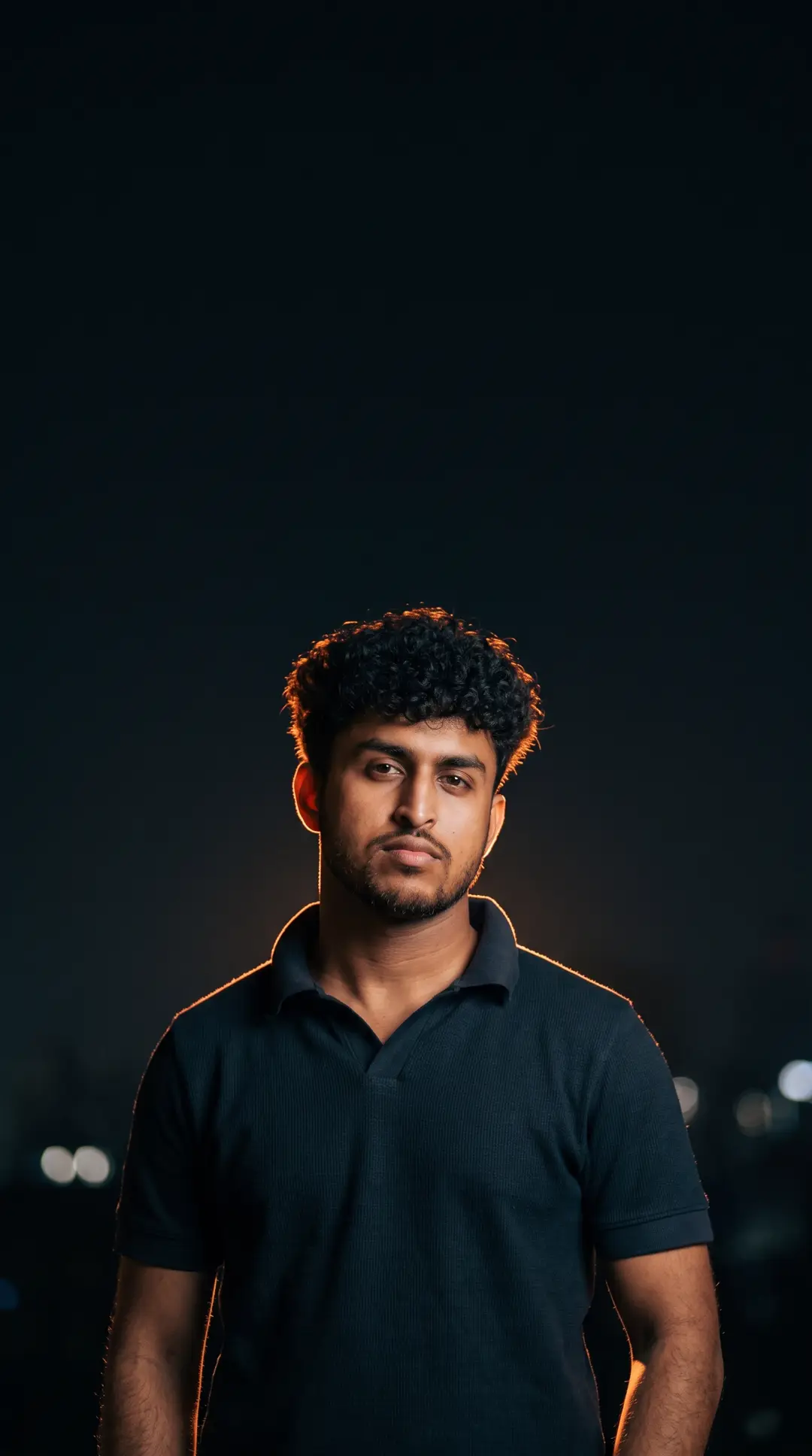 Portrait of Alvin in a dark polo shirt
